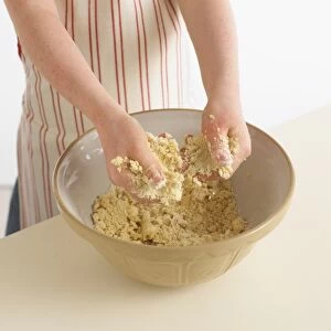 Girl using hands to mix pastry ingredient