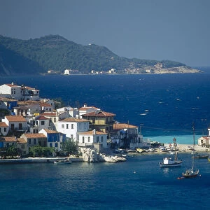 Greece, Samos, Kokkaki, beach and harbour, flanked by its twin headlands, dark blue sea beyond