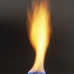 Natural gas burner and large orange and blue flame, close-up