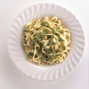 Trenette al pesto, trennette pasta with pesto sauce and basil leaves, a typical dish from Genoa, Liguria, Italy, view from above