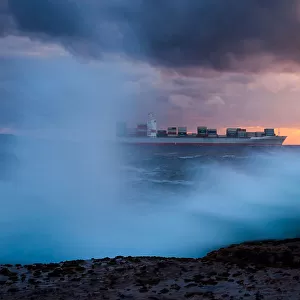 Container Ship sailing in to the Sunrise