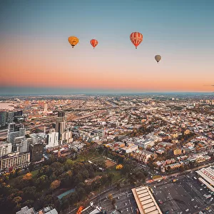 Hot air balloons over Melbourne city at dawn