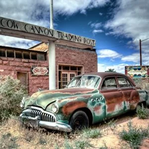 Abandoned 1950s car outside a desert trading post