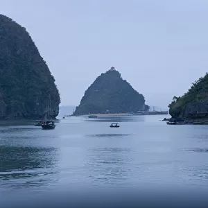 Boats and islands at dusk on Vietnamese bay