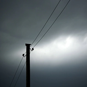 Power pole against a cloudy sky