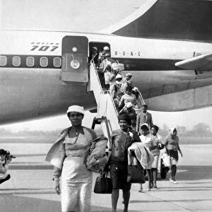 Chartered Boeing 707 jet airliners are flying in hundreds of coloured immigrants