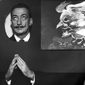 Salvador Dali Poses next to his masterpiece