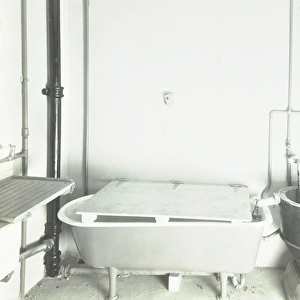 Dinmont Estate, Hackney Road: kitchen with bath and water pump, London, 1936 (b / w photo)