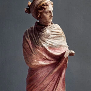 Greek art: small polychrome terracotta sculpture depicting a woman drapee. 3rd century BC