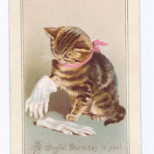 A Victorian Birthday card of a kitten playing with a pair of gloves, c