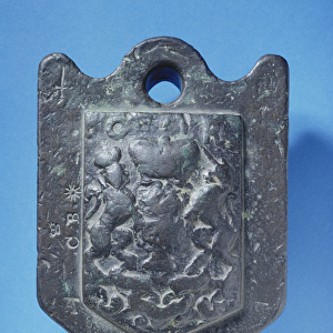 Wool-weight (14 pounds) cast with the Stuart arms and stamped C. B, 17th century (lead)