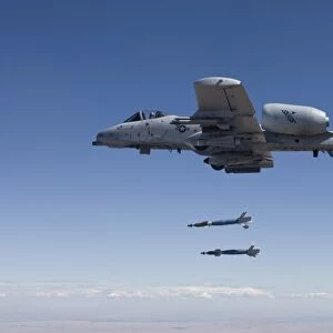 An A-10C Thunderbolt releases two GBU-12 laser guided bombs