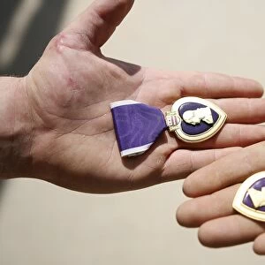Purple Heart recipients display their medals in their hands