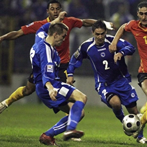 Marouane Fellaini-Bakkioui of Belgium is challanged by Bosnias Boris Pandza and Dzemal Berberovic during their 2010 World Cup qualifying soccer match in Zenica