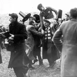 Wales rugby fans chairing the Welsh full back Terry Davis from the pitch after a 5 nations match 1953