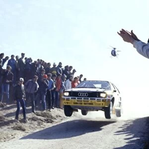 1984 FIA World Rally championship: Spectators watch on as a Audi Quattro gets airborne