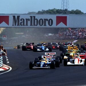 Ricardo Patrese defends his Pole Position from the advances of Ayrton Senna