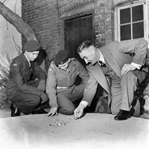Bernard Wilcock Seen here playing marbles with a group of soldiers. March 1953 D1555