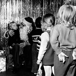 Children waiting in line to see Father Christmas at a store in Ilford, Essex