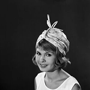 Clothing: Fashion: Hats: Model: Elizabeth Duke. August 1962 B1499