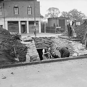 Council workmen constructing a public air raid shelter outside Lloyds Bank in Church Road