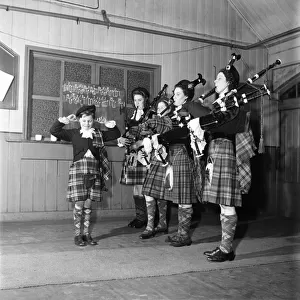 Donald Ross the Woolwich Pipe bands mascot, with his finers in his ears