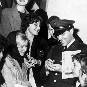 Elvis Presley signing autographs while in Germany on service with the U. S. army
