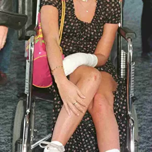 EMMA BUNTON BABY SPICE OF THE SPICE GIRLS RETURNS TO HEATHROW IN A WHEELCHAIR AFTER