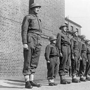 Frank Vincent, the smallest man in the army lines up with the taller members of his