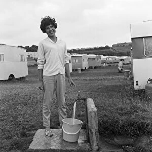 A holidaymaker collects water at Sandy Bay Caravan site, near Exmouth, Devon