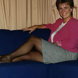 Jill Dando TV Presenter sitting with legs up on sofa on BBC Breakfast time