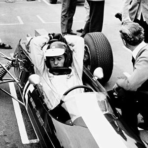 Jim Clark racing driver in car arms stretched over helmet 1965 Scottish World Champion
