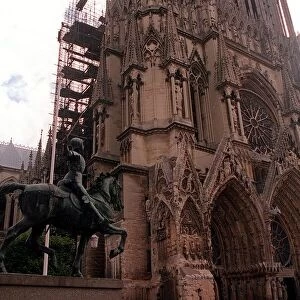 Joan of Arc statue looking up at the Cathedral at Reims Rheims France