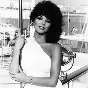 Joan Collins posing on quayside at Cannes film festival - May 1979