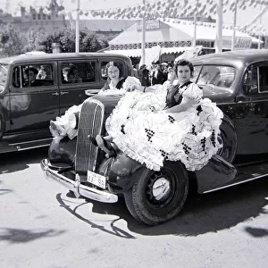 Local women of Seville sitting on the bonnet of a car Circa 1940
