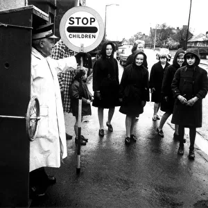 Lollipop man Thomas Glen, aged 72, in his mobile sentry box. 10th March 1967