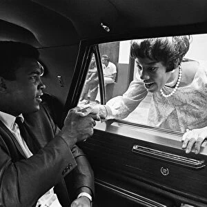 Muhammad Ali shakes a females hand from his car. 31st August 1967