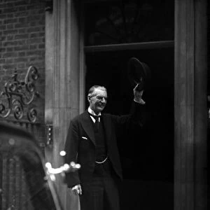 Neville Chamberlain Prime Minister outside 10 Downing Street raises his hat to