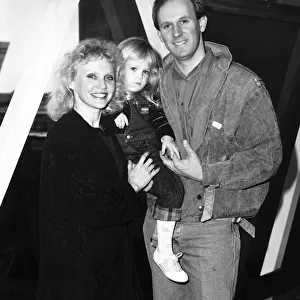 Peter Davison actor with his wife Sandra Dickenson and baby Georgia at Heathrow before