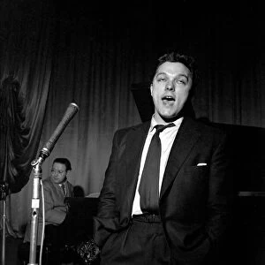 Singer Dickie Valentine seen here performing on stage. 1954 A134a-001