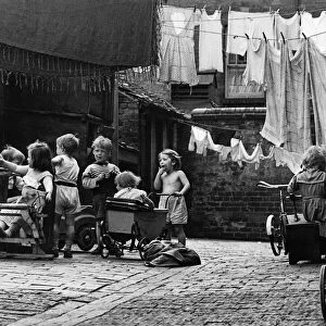 Slum housing in Birmingham, West Midlands. Children at play in the back streets of