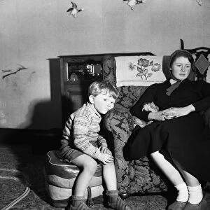 A small boy watches television. 12th March 1954 Howard is four