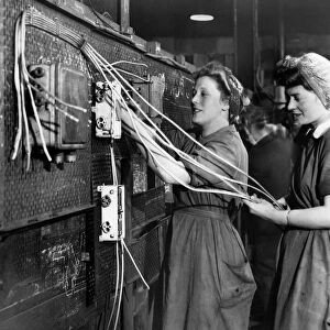 Women wiring up warship which nears completion in a Scottish Shipyard