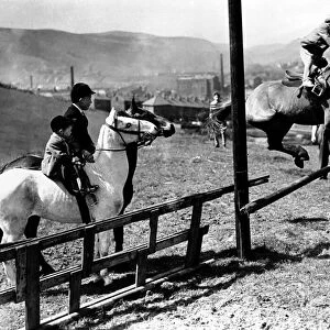 Three very young boys: Peter, Tony, & Kaye, riding horses at their father