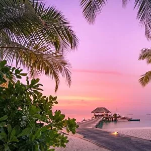 Beautiful sunset beach scene. Wooden jetty colorful sky and clouds view with calm sea and relaxing tropical mood. Exotic tropical landscape nature