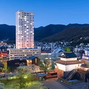 Kofu, Yamanashi, Japan downtown cityscape and corner castle tower at twilight