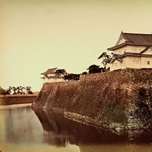 A bastion of the fort of Osaka, Japan, surrounded by a moat full of water