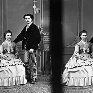 Stereoscopic photograph taken in studio, portraying a young couple in elegant nineteenth century dress